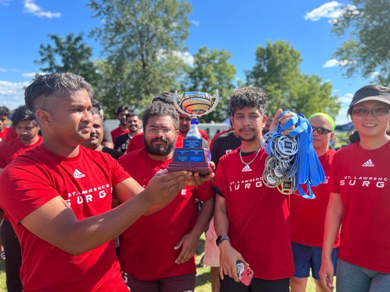 Members of the SLC dragon boat race team hold up their trophy after winning second place